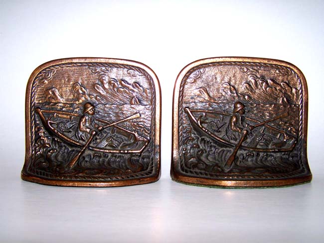 A charming small pair of Antique Bookends circa 1910 depicting a fisherman in a dory